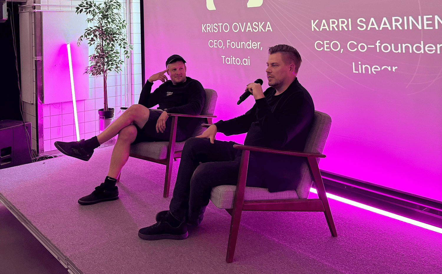 Image of speakers on stage: Karri Saarinen from Linear and Kristo Ovaska from Taito.ai