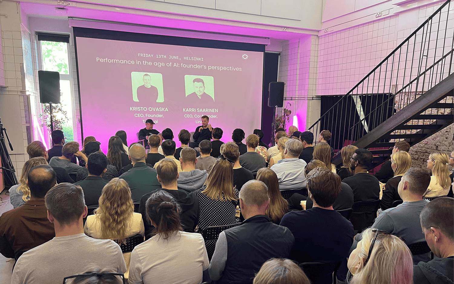 Audience listening to Kristo Ovaska and Karri Saarinen discussing performance in the age of AI at a Taito-hosted event at Maria01 in Helsinki on June 13th.